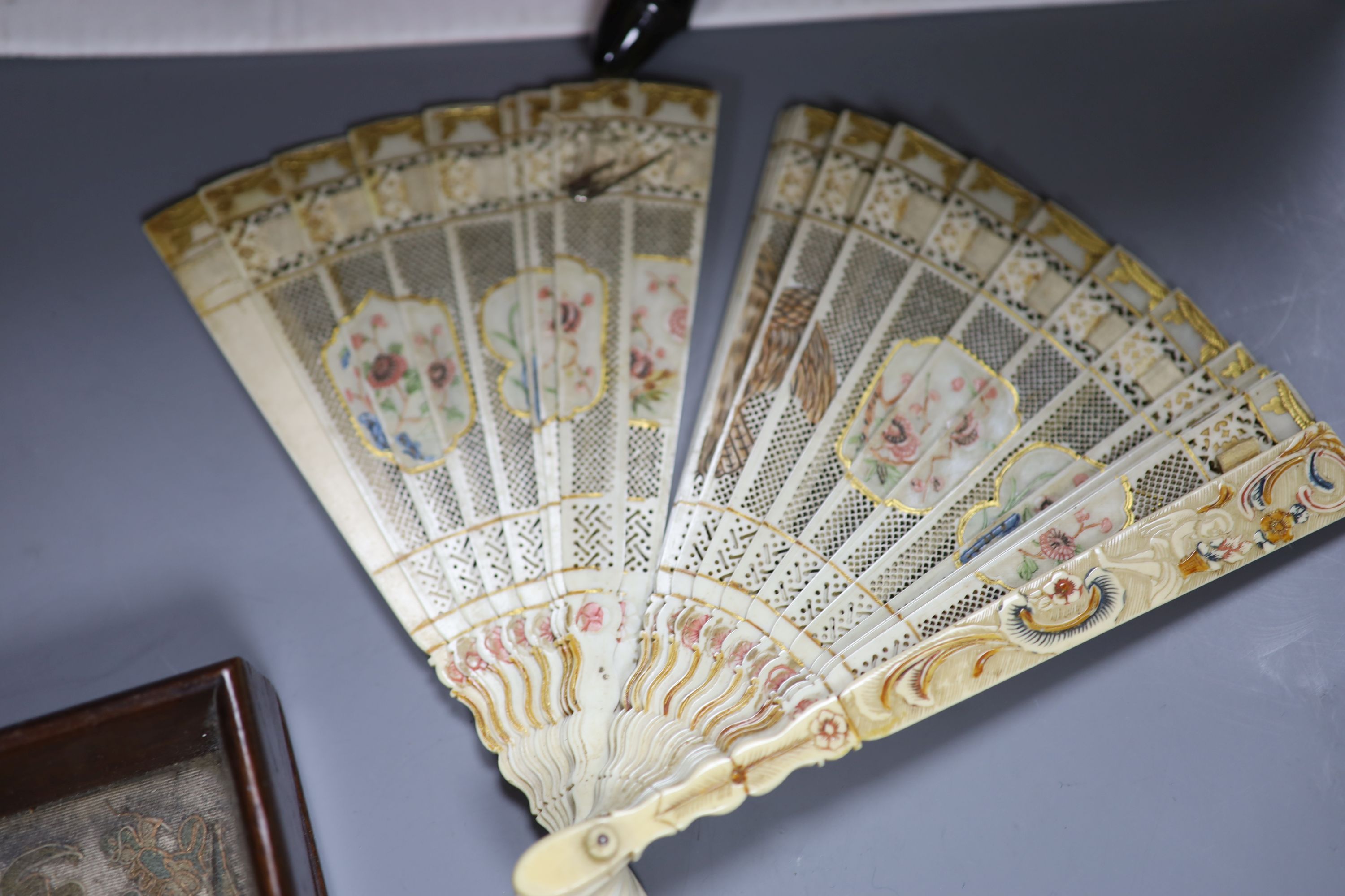 A quantity of mixed collectables including a tortoiseshell tray, a Chinese needlework, a silver paperknife, fans, jewellery boxes, etc.